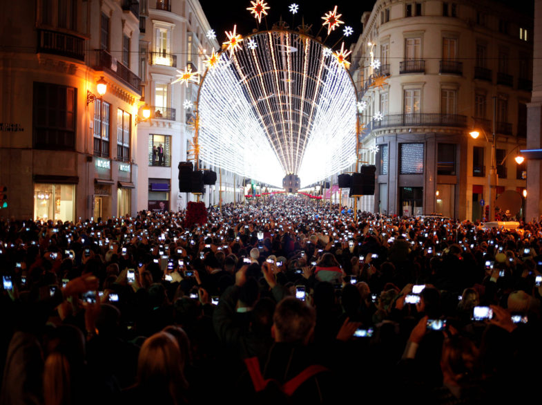 People use mobile phones to take pictures as Christmas lights are turned on to mark the start of the Christmas season at Marques de Larios street in downtown Malaga, southern Spain, November 24, 2016. REUTERS/Jon Nazca