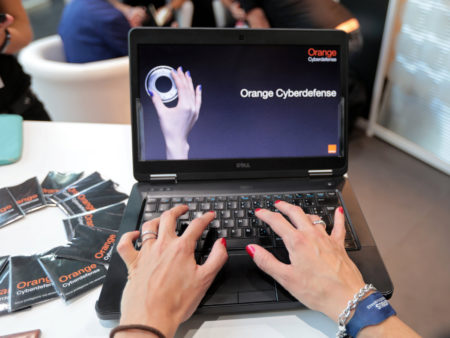 An Orange employee poses as she uses a computer at "Les Assises" the cybersecurity event in Monaco October 5, 2016. 